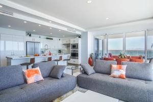 a living room with two couches and a kitchen at Sublime 3 bedroom condo Encantame Towers Verano 801 in Playa Encanto