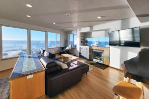 a living room with a couch and a fireplace at Spectacular Ocean Views! Whaley Nice in Yachats