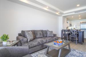 a living room with a couch and a table at Panoramic beach front condo Verano 1703 in Puerto Peñasco