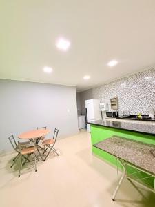 a kitchen and dining room with a table and chairs at Nina lar in Boa Vista