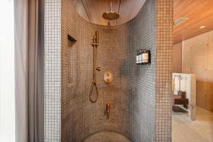 a bathroom with a shower with a glass door at 23 Living in Medellín +90 photos