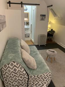 a bedroom with a bed and a chair at 45 Grande Rue bis in Ault +34 photos