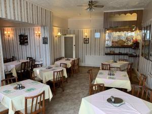 a restaurant with tables and chairs with white tablecloths at Bramleigh Hotel in Blackpool