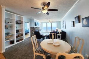 a dining room and living room with a table and chairs at Spectacular Ocean Front Condo with Community Club House & Pool! Whale Crossing in Depoe Bay