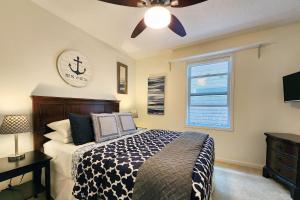 a bedroom with a bed and a clock on the wall at Spectacular Ocean Front Condo with Community Club House & Pool! Whale Crossing in Depoe Bay