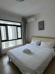 a bedroom with a bed with a stuffed animal on it at Forest City Homestay 森林民宿 in Gelang Patah