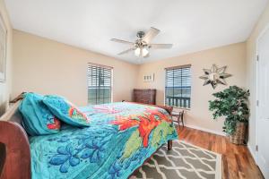 a bedroom with a bed and a ceiling fan at Escape Bay Views Large Deck Group Ready in Port Bolivar