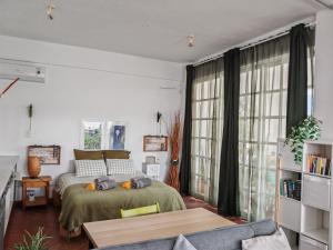 a bedroom with a bed and a large window at Oneiro glico in Agia Marina Aegina +182 photos
