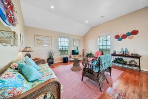 a living room with a couch and chairs at Escape Bay Views Large Deck Group Ready in Port Bolivar