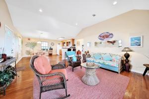 a living room with chairs and a couch at Escape Bay Views Large Deck Group Ready in Port Bolivar