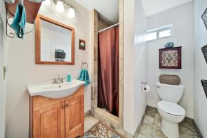 a bathroom with a sink toilet and a mirror at Escape Bay Views Large Deck Group Ready in Port Bolivar +21 photos