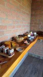 a table with many different types of food on it at Hospedaria Sol & Lua in São Bento do Sapucaí