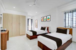 a hotel room with two beds and a bathroom at Townhouse Bangalore Kundalahalli Metro Station in Bengaluru +24 photos