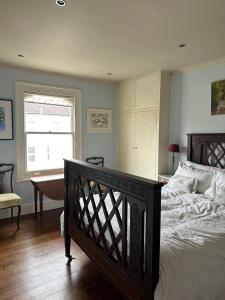 a bedroom with a large bed and a window at Central Boutique Townhouse in London