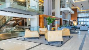 a lobby with chairs and tables in a building at CENTURY CLUB - Luxury Apartment Hotels in Cape Town +63 photos