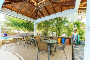 a patio with tables and chairs and a pool at Hotel Mar Rey in Tamarindo