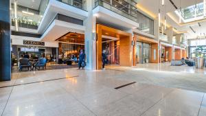 a lobby of a shopping mall with people in it at CENTURY CLUB - Luxury Apartment Hotels in Cape Town