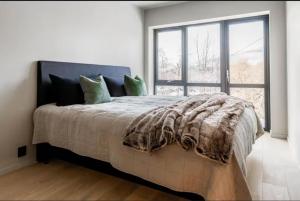 a bedroom with a large bed with a large window at New house in the center of Trysil 2 in Trysil