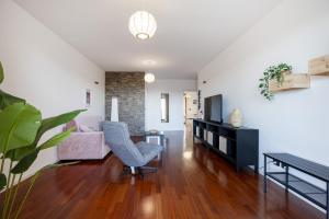 a living room with a couch and a chair at Casa Diletta— Bright Spaces, Warm Moments in Stazione Bari Centrale