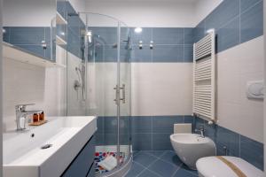 a bathroom with a toilet and a sink and a shower at Casa Diletta— Bright Spaces, Warm Moments in Stazione Bari Centrale +13 photos