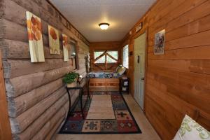 a hallway in a log cabin with wooden walls at Jones Riverside Cabin in Utopia +9 photos