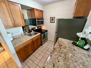 a kitchen with a sink and a refrigerator at Lahaina Shores #316 in Lahaina