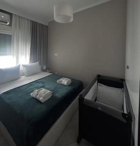 a bedroom with a bed with two towels on it at Amara Luxury in Kavála
