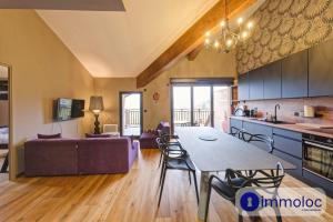 a kitchen and living room with a table and a couch at Apartment in Auron in Auron
