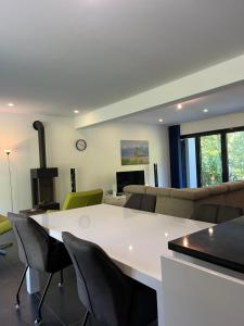 a living room with a white table and chairs at Villa Bukvic in Zavidovići