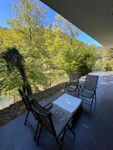 a table and chairs on a patio with a view at Villa Bukvic in Zavidovići