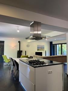 a kitchen and living room with a stove top oven at Villa Bukvic in Zavidovići