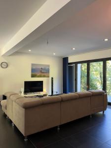 a large couch in a living room with a tv at Villa Bukvic in Zavidovići