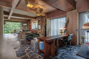 an office with a large wooden desk and chairs at 23 Living in Medellín