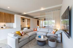 a living room with a couch and a table at Aura Anse Marcel in Anse Marcel 