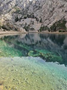 a body of water with mountains in the background at Stinica apartma Paradise in Stinica