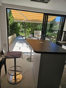 a kitchen with a bar with a view of a patio at Stinica apartma Paradise in Stinica