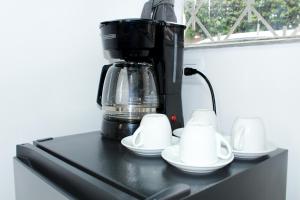 a coffee maker sitting on top of a black counter at Garden's Aparta hotel in Bogotá +170 photos