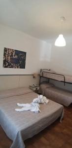 Postel nebo postele na pokoji v ubytování Hotel Ai Tufi