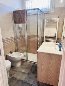 a bathroom with a shower and a toilet and a sink at Giardino Toscano in Bagnone +42 photos