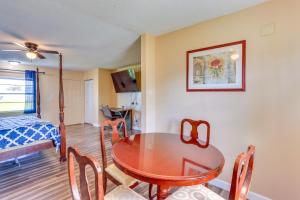 a dining room with a table and chairs and a bed at Walk to Lake Jackson Convenient Studio in Sebring in Sebring