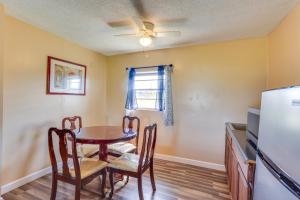 a dining room with a table and chairs and a refrigerator at Walk to Lake Jackson Convenient Studio in Sebring in Sebring