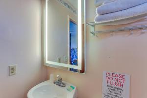a bathroom with a sink and a mirror and towels at Walk to Lake Jackson Convenient Studio in Sebring in Sebring +16 photos