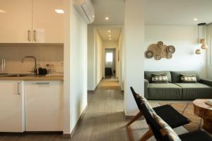 a kitchen and a living room with a couch at Bay House in Ponta Delgada