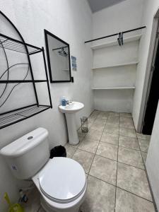 a bathroom with a white toilet and a sink at Casa Pelíkano Uvita in Uvita +31 photos