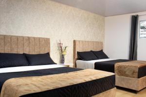 Ένα ή περισσότερα κρεβάτια σε δωμάτιο στο Garden's Aparta hotel