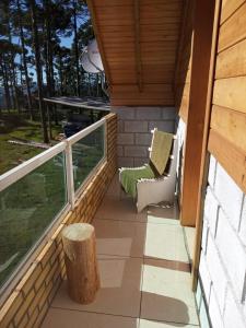 a balcony of a cabin with a table and chairs at Cabana Mundo Novo in Mundo Novo
