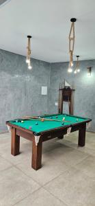a green snooker table in a room at Pousada Coisa Nossa in Itanhaém +13 photos