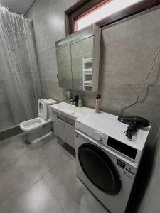 een badkamer met een wasmachine en een wastafel bij Lucky Houseee in Grigoleti