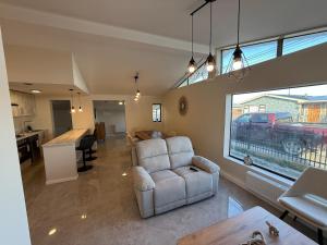 un grand salon avec un canapé et une cuisine dans l'établissement Casa cerca costanera central, à Punta Arenas
