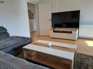 a living room with a couch and a coffee table at Apartma Gašper in Šentjur